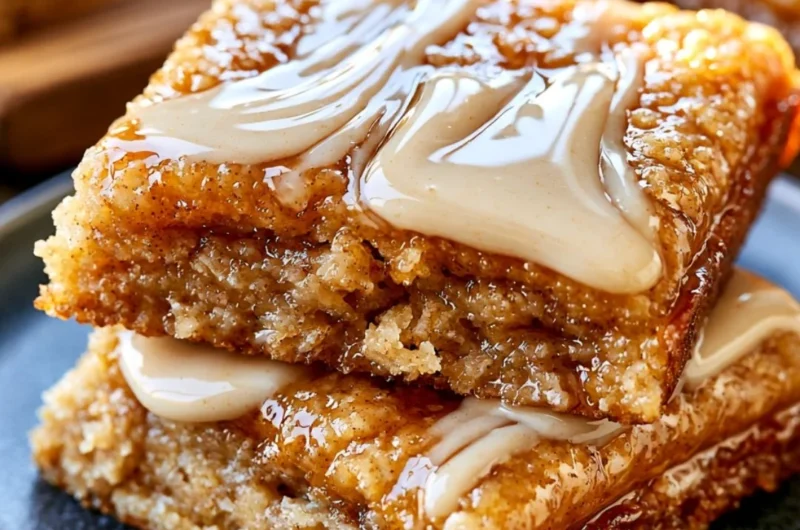 Deliciously soft baked maple donut bars on a rustic wooden table
