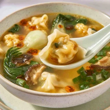 Bowl of quick and easy wonton soup garnished with green onions