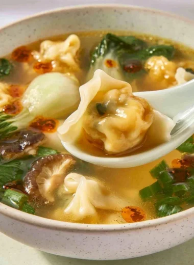 Bowl of quick and easy wonton soup garnished with green onions