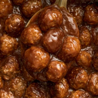 Slow Cooker Salisbury Steak Meatballs served on a plate with gravy and vegetables.