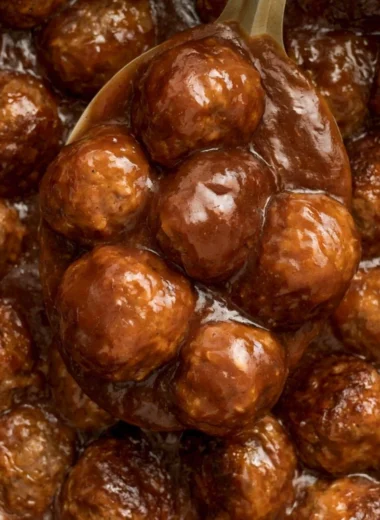 Slow Cooker Salisbury Steak Meatballs served on a plate with gravy and vegetables.