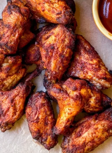 Delicious Traeger smoked chicken wings ready to serve at a backyard barbecue.