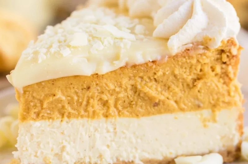 Cozy eggnog pumpkin cheesecake topped with whipped cream and cinnamon
