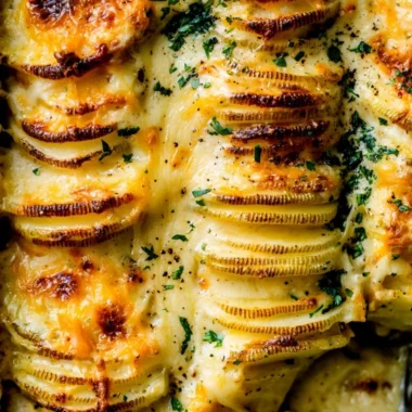 Cozy cheesy scalloped potatoes baked to perfection in a creamy sauce.