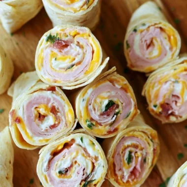 Turkey Bacon Cheese Pinwheels served on a platter with fresh vegetables