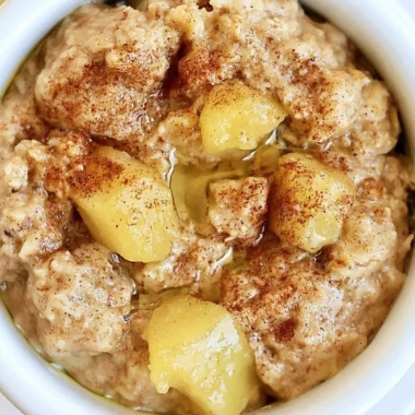 Bowl of homemade stovetop apple cinnamon oatmeal topped with fresh apples