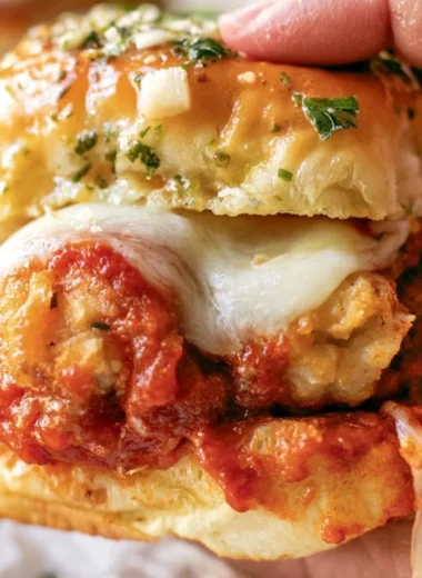 Chicken Parmesan Sliders topped with melted cheese and marinara sauce