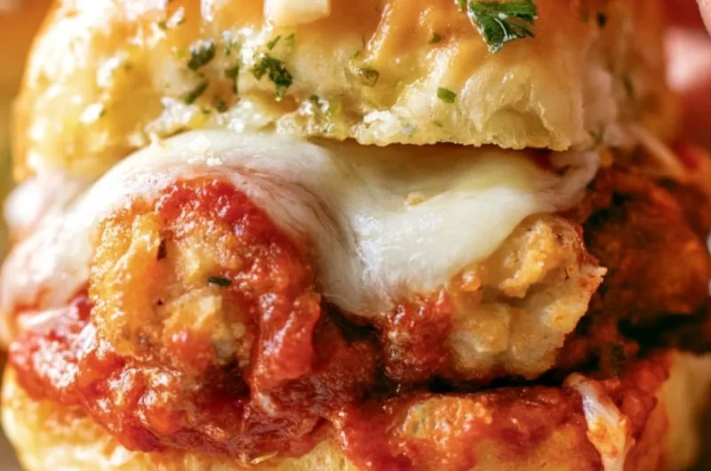 Chicken Parmesan Sliders topped with melted cheese and marinara sauce