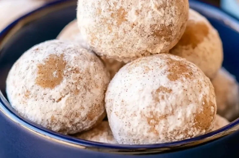Delicious Gingerbread Snowball Cookies on a festive baking tray