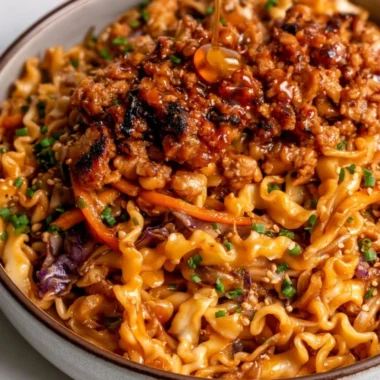 High protein noodle bowl with honey garlic ground chicken and colorful vegetables