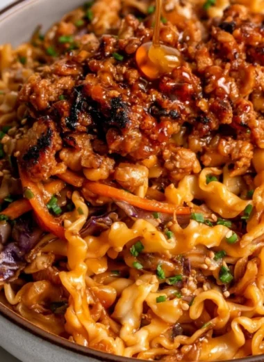 High protein noodle bowl with honey garlic ground chicken and colorful vegetables
