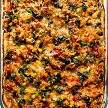 Delicious protein-packed burrito bake topped with cheese and veggies.