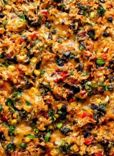 Delicious protein-packed burrito bake topped with cheese and veggies.