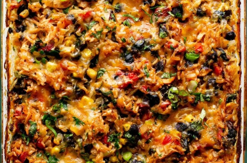Delicious protein-packed burrito bake topped with cheese and veggies.