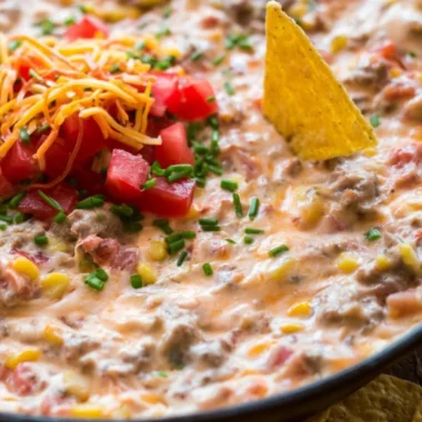 Delicious Sausage Queso Dip served in a bowl with tortilla chips