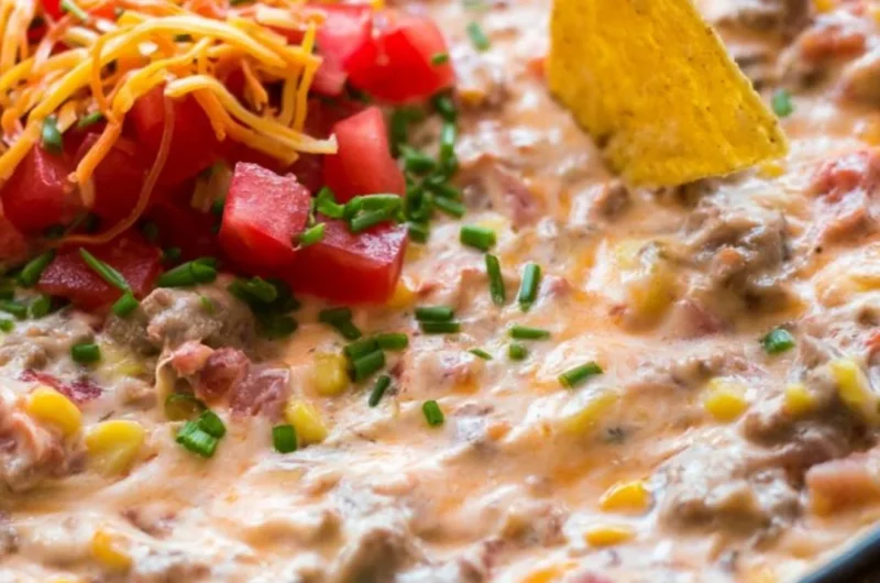 Delicious Sausage Queso Dip served in a bowl with tortilla chips